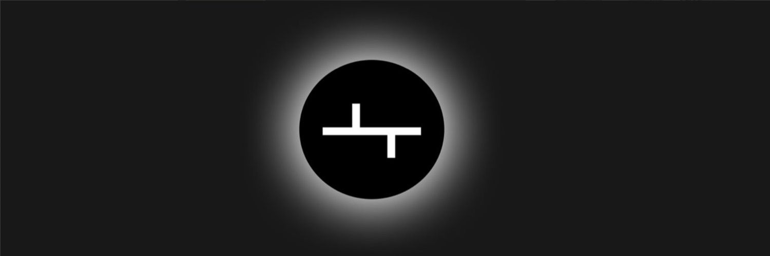 white Tokemak logo on black background