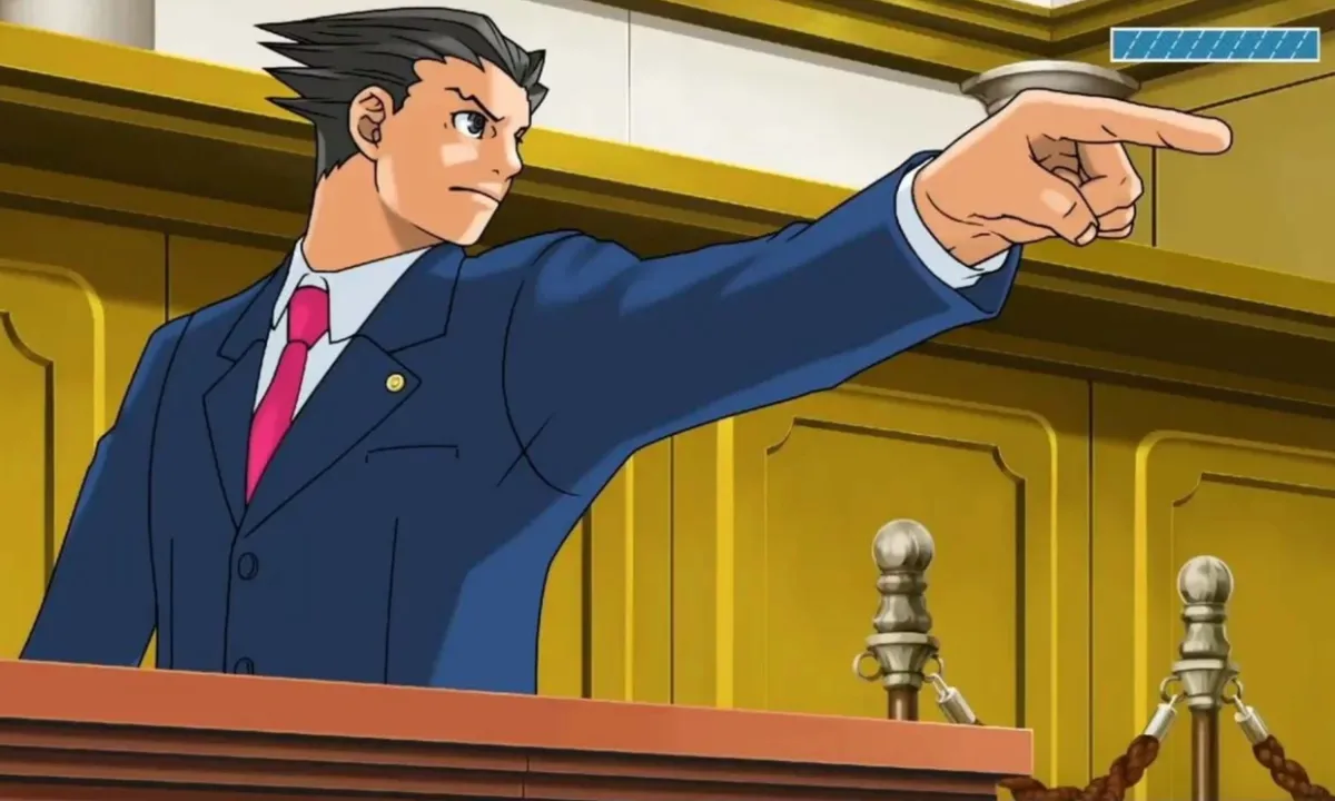 a lawyer in a suit stands behind a table, with one arm raised and finger pointing 
